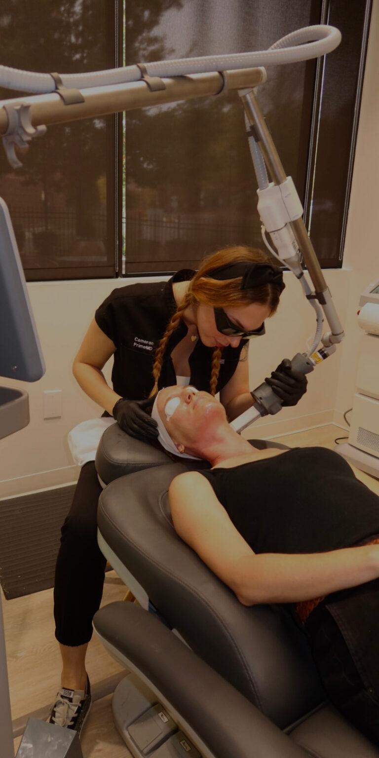 Provider performing CO2 laser treatment on a patient’s face at Prime MD Aesthetics & Wellness for skin resurfacing and rejuvenation.