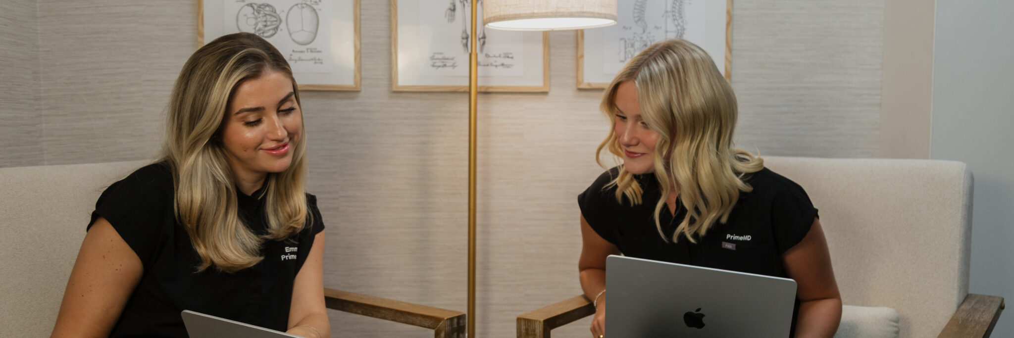 Two medical care coordinators discussing a patient's upcoming treatment plans, representing Prime MD's holistic wellness approach that includes men's hormone replacement therapy, women's hormone therapy, metabolic health, and more.